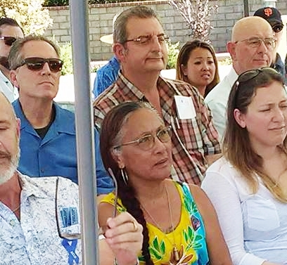 Bill Taormina behind Smith in Plaid Shirt